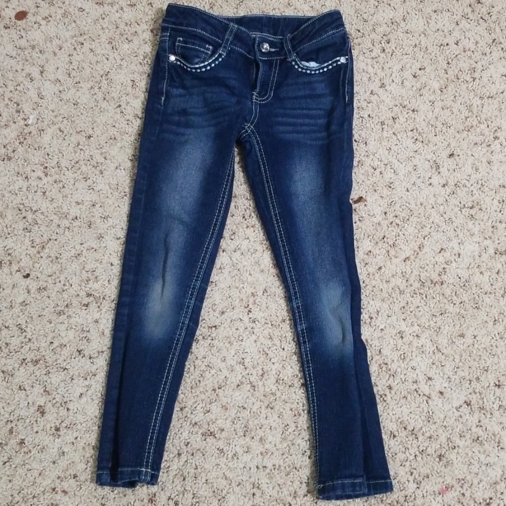 A pair of navy blue jeans, embroidered with jewels